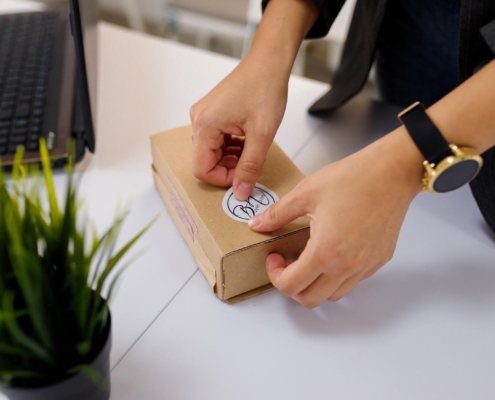 Person putting label on box