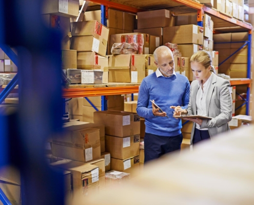Two people talking in warehouse