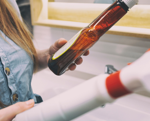 Woman reads the composition of cleaning products after buying them in the supermarket