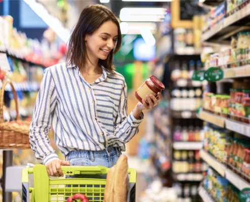 Person at store looking at food label